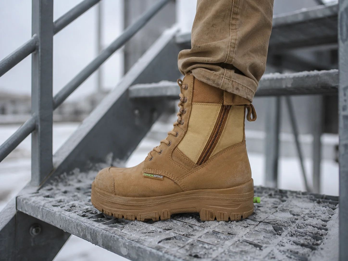 A GEN 3 boot planted on the iced metal grating of an exterior industrial staircase